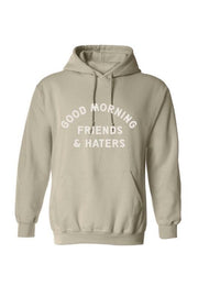 tan hooded sweatshirt with "Good Morning Friends & Haters" printed on middle front of sweatshirt in white writing. 